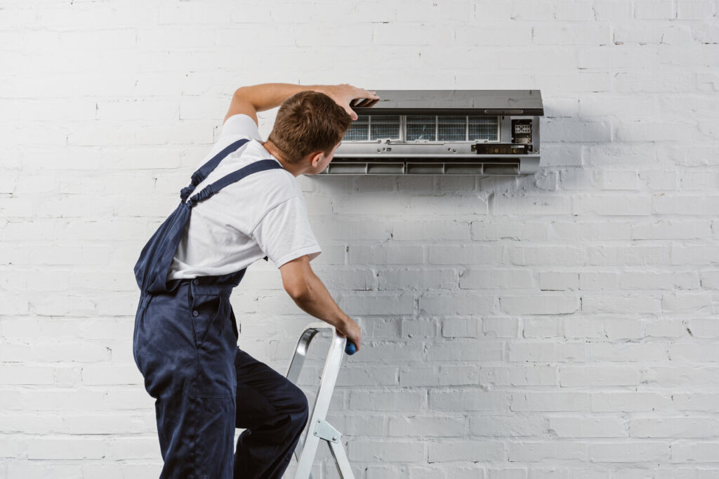 rsz rear view of air conditioner repairman standing on 2023 11 27 05 21 54 utc